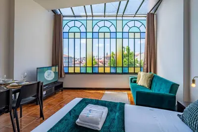 a living room with a large stained glass window at Heritage Oporto Downtown in Porto