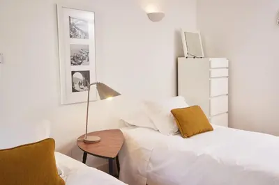 a white bedroom with a bed and a table at ChillHouse_Porto in Porto