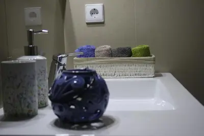 a bathroom counter with a blue vase next to a sink at ChillHouse_Porto in Porto