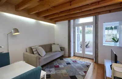 a living room with a couch and a tv at ChillHouse_Porto in Porto