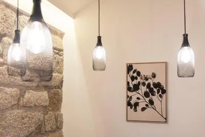 three lights hanging in a room with a picture at GuestReady - Cosy getaway in Porto in Vila Nova de Gaia