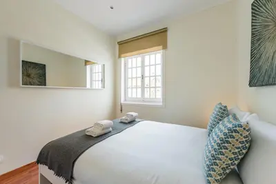a bedroom with a white bed and a window at GuestReady - Cosy getaway in Porto in Vila Nova de Gaia