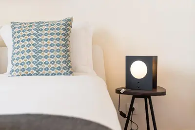 a bed with a speaker on a table next to a bed at GuestReady - Cosy getaway in Porto in Vila Nova de Gaia