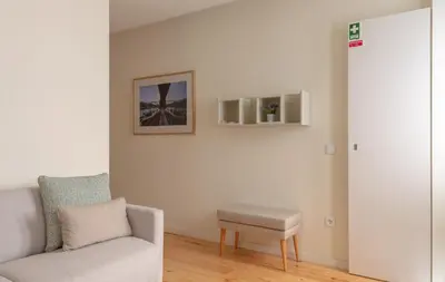 a living room with a couch and a stool at GuestReady - Catorze de Outubro Houses 427 in Vila Nova de Gaia
