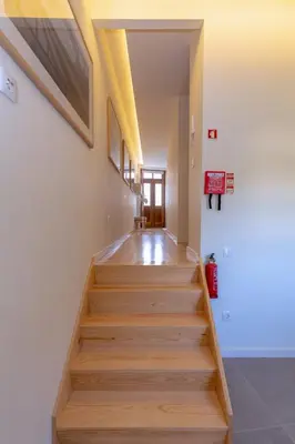 a hallway with wooden stairs in a building at GuestReady - Catorze de Outubro Houses 427 in Vila Nova de Gaia