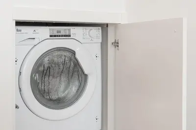 a white washing machine in a white room at GuestReady - Port Studio 1 in Vila Nova de Gaia