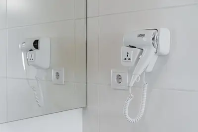 a white phone on a wall in a bathroom at GuestReady - Port Studio 1 in Vila Nova de Gaia