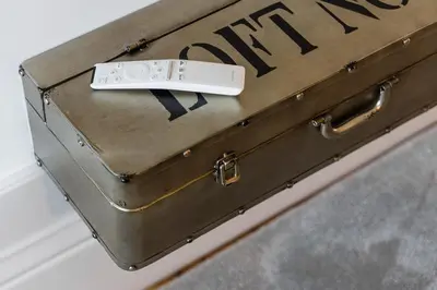 a suitcase with a remote control sitting on top of it at GuestReady - Loft 515 in Porto