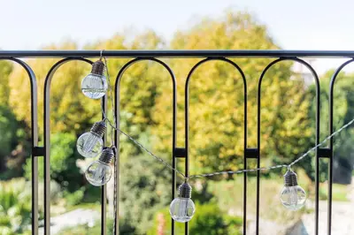 a group of glass lights hanging from a fence at GuestReady - Loft 515 in Porto