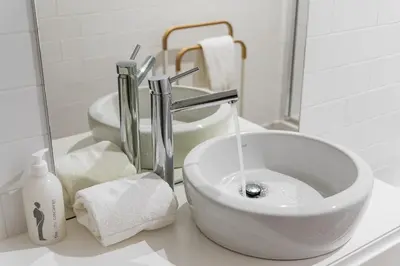 a sink with water coming out of it in a bathroom at GuestReady - Loft 515 in Porto