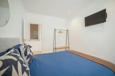 a bedroom with a blue bed and a television at Douro Panoramic Views by Vacationy in Porto