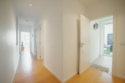 an empty hallway with white walls and a window at Douro Panoramic Views by Vacationy in Porto