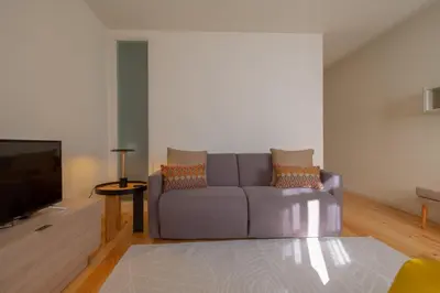 a living room with a couch and a tv at GuestReady - Catorze de Outubro Houses - 387 in Vila Nova de Gaia