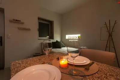 a table with two wine glasses and a candle on it at Lady Lapa by Lady Collection in Porto