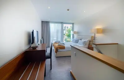 a hotel room with a bed and a desk at Oca Flores Hotel Boutique in Porto