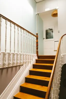 a staircase in a building with wood and metal railing at Studio Faria Guimarães in Porto