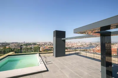 a swimming pool on the roof of a house at Brand New Luxurious Ap T2 - Amazing View- with garage in Vila Nova de Gaia