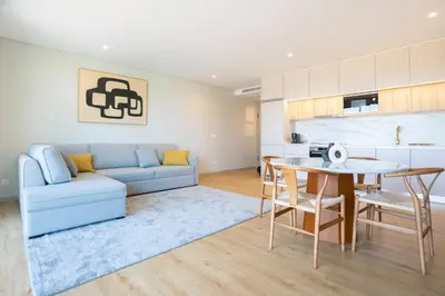 a living room with a blue couch and a table at Brand New Luxurious Ap T2 - Amazing View- with garage in Vila Nova de Gaia