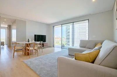 a living room with a couch and a table at Brand New Luxurious Ap T2 - Amazing View- with garage in Vila Nova de Gaia