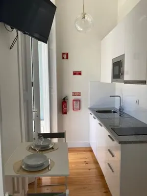 a kitchen with a red teddy bear sitting on the counter at Pombeiro Apartments in Porto