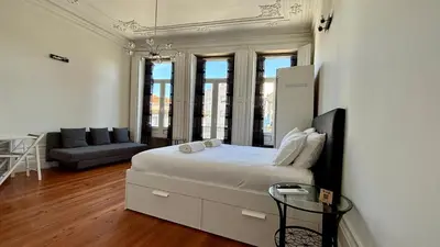 a bedroom with a bed with towels on it at Pombeiro Apartments in Porto