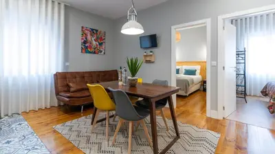 a patio with orange chairs and a sign on the ground at Stop & Relax - Parking in Porto