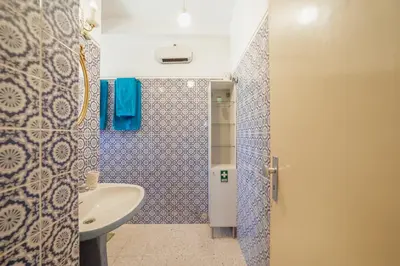 a bathroom with a sink and a shower at Downtown Classic With Terrace by Vacationy in Porto