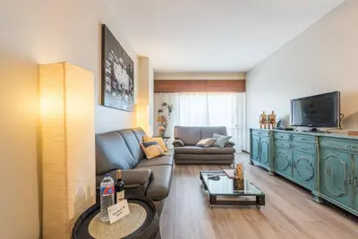 a living room with a couch and a television at Woodwork Apartment in Porto