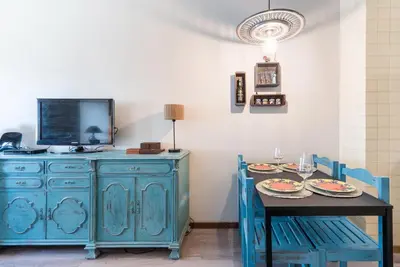 a dining room with a blue cabinet and a table at Woodwork Apartment in Porto