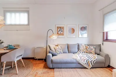 a living room with a couch and a table at Apartamento com terraço in Porto