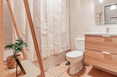 a bathroom with a toilet and a sink and a shower at Apartamento com terraço in Porto