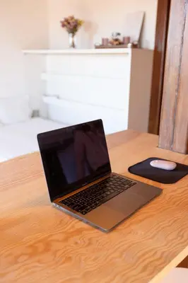a laptop computer sitting on top of a wooden table at Studio para 4 pessoas no Porto in Porto