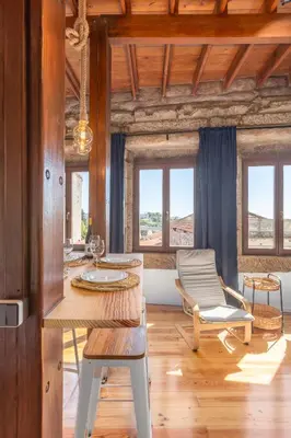 a living room with a table and a chair at Studio para 4 pessoas no Porto in Porto