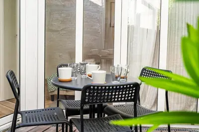 a table and chairs sitting on a balcony with a table and chairs at Oporto Nura Apartment Downtown in Porto