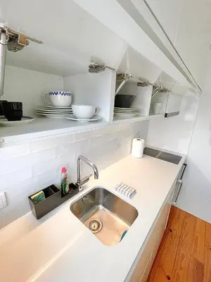 a kitchen counter with a sink in a kitchen at Cozy Studio in the Heart of Porto in Porto