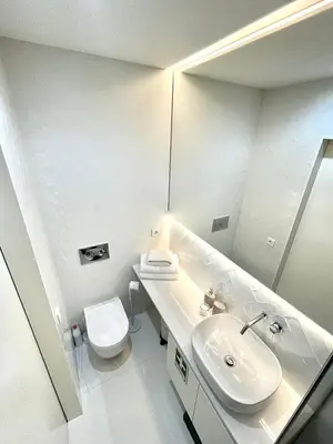 a white bathroom with a sink and a toilet at Cozy Studio in the Heart of Porto in Porto