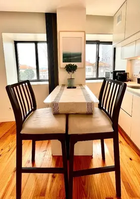 a dining room table with two chairs and a table and chairsktop at Cozy Studio in the Heart of Porto in Porto