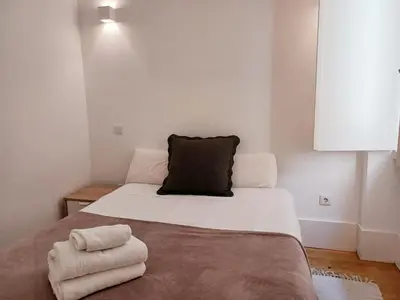 a bedroom with a bed with two towels on it at Foryou-2-BonfimPorto in Porto