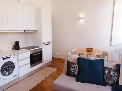 a living room with a couch and a table and a kitchen at Foryou-2-BonfimPorto in Porto