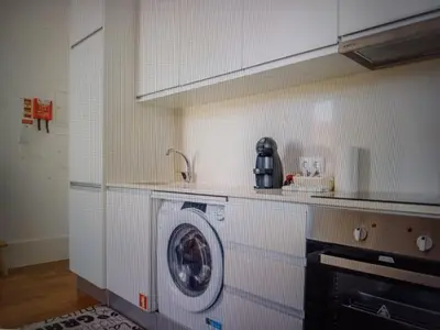 a kitchen with a washing machine and a sink at Foryou-2-BonfimPorto in Porto