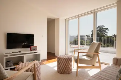 a living room with a couch and a tv at Vila Catarina Luxury Apartments in Porto