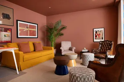 a living room with a yellow couch and chairs at Vila Catarina Luxury Apartments in Porto