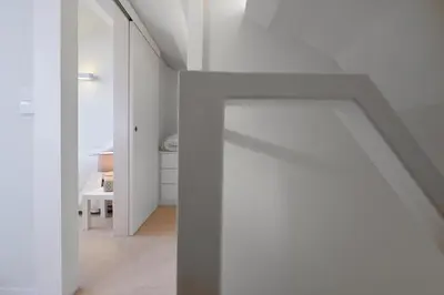 a white room with a door and a hallway at Dux in Porto