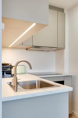 a kitchen with a stainless steel sink and white cabinets at Rola Art Work Studio II by DA'HOME in Porto