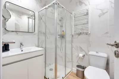 a bathroom with a shower and a toilet and a sink at Rola Art Work Studio II by DA'HOME in Porto