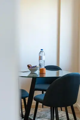 a table with two chairs and a bottle of water on it at Rola Art Work Studio II by DA'HOME in Porto