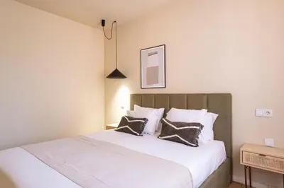 a bedroom with a bed with two pillows on it at Guesthouse Bonjardim by LovelyStay in Porto