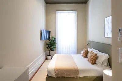 a bedroom with a bed and a window at Guesthouse Bonjardim by LovelyStay in Porto