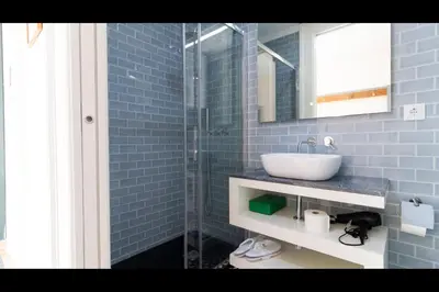 a bathroom with a sink and a glass shower at AM Haven Studios - by Unique Hosts in Porto