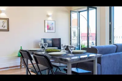 a dining room table with plates and wine glasses at AM Haven Studios - by Unique Hosts in Porto